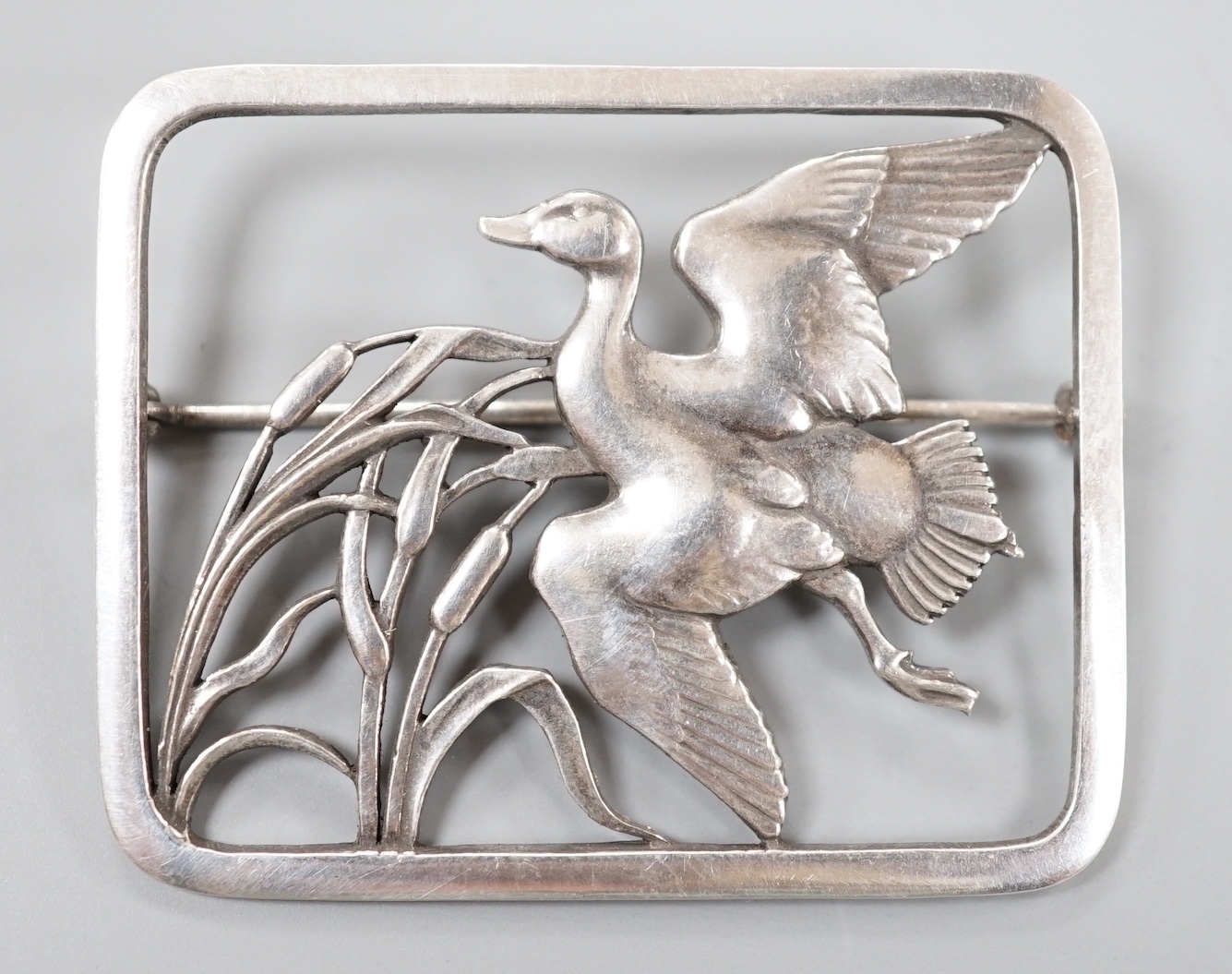 A Georg Jensen sterling 'duck in flight amid reeds' rectangular brooch, no. 300, 47mm.